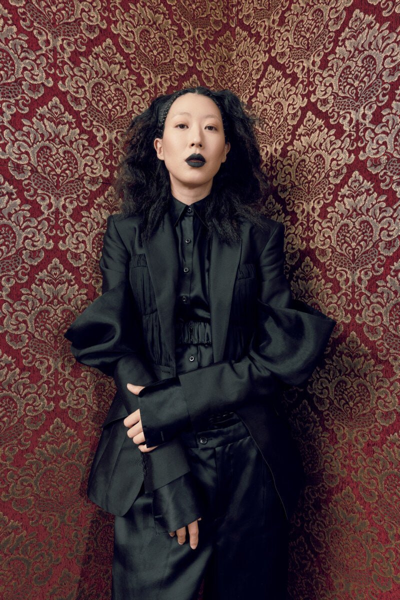 Model in suited boudoir fashion