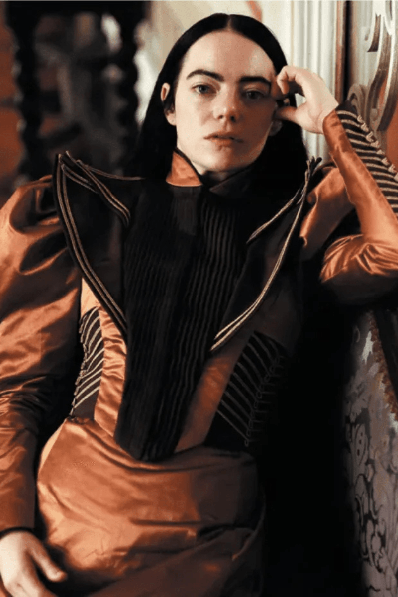 Avant-garde copper-and-black gown with pleated bodice and dramatic Victorian-inspired collar