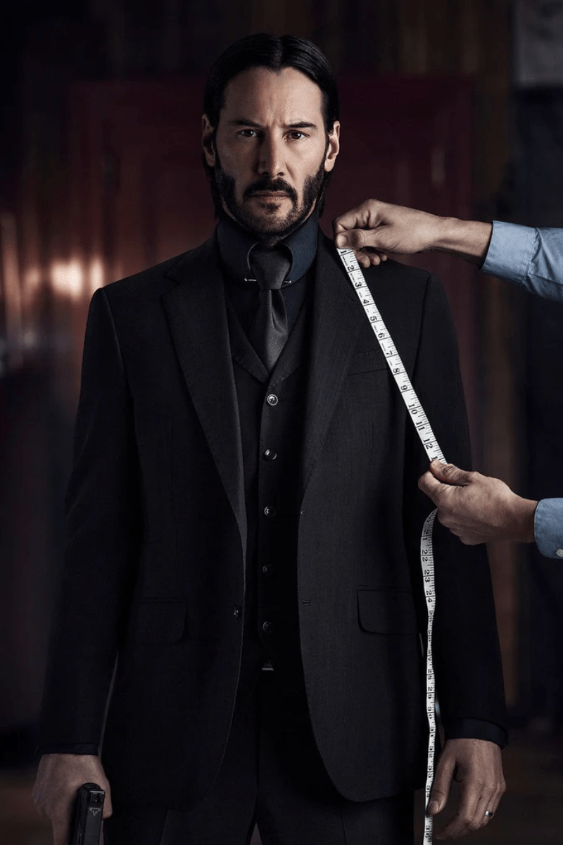 Keanu Reeves getting measured for a suit