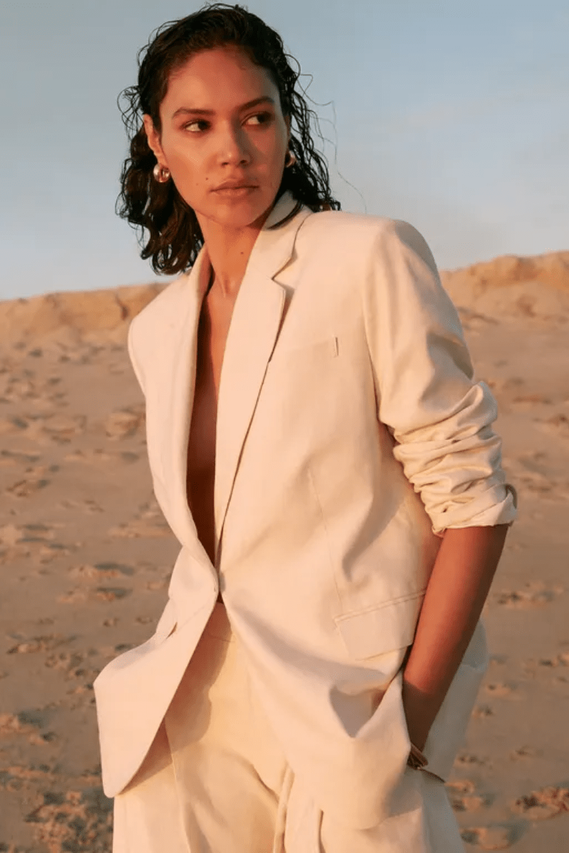 Model wearing a cream tailored suit