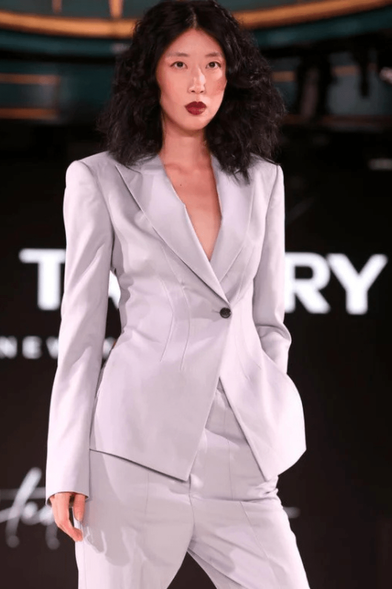 A model in a custom gray suit walks The Tailory New York runway