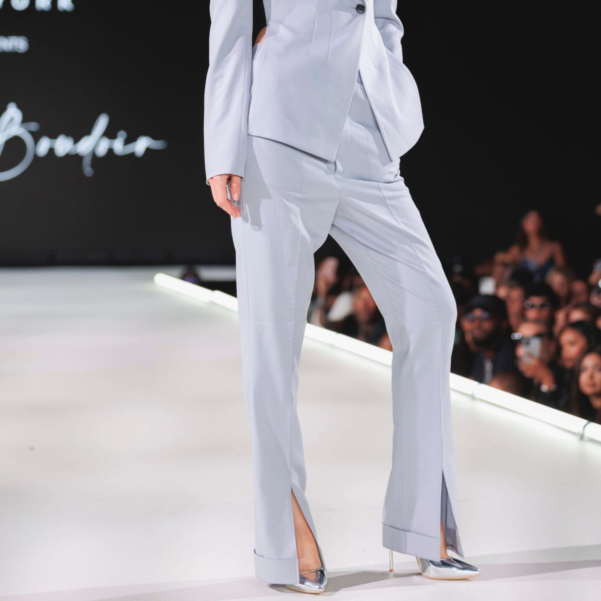 Tailory white flared trousers styled outdoors with front-slit movement