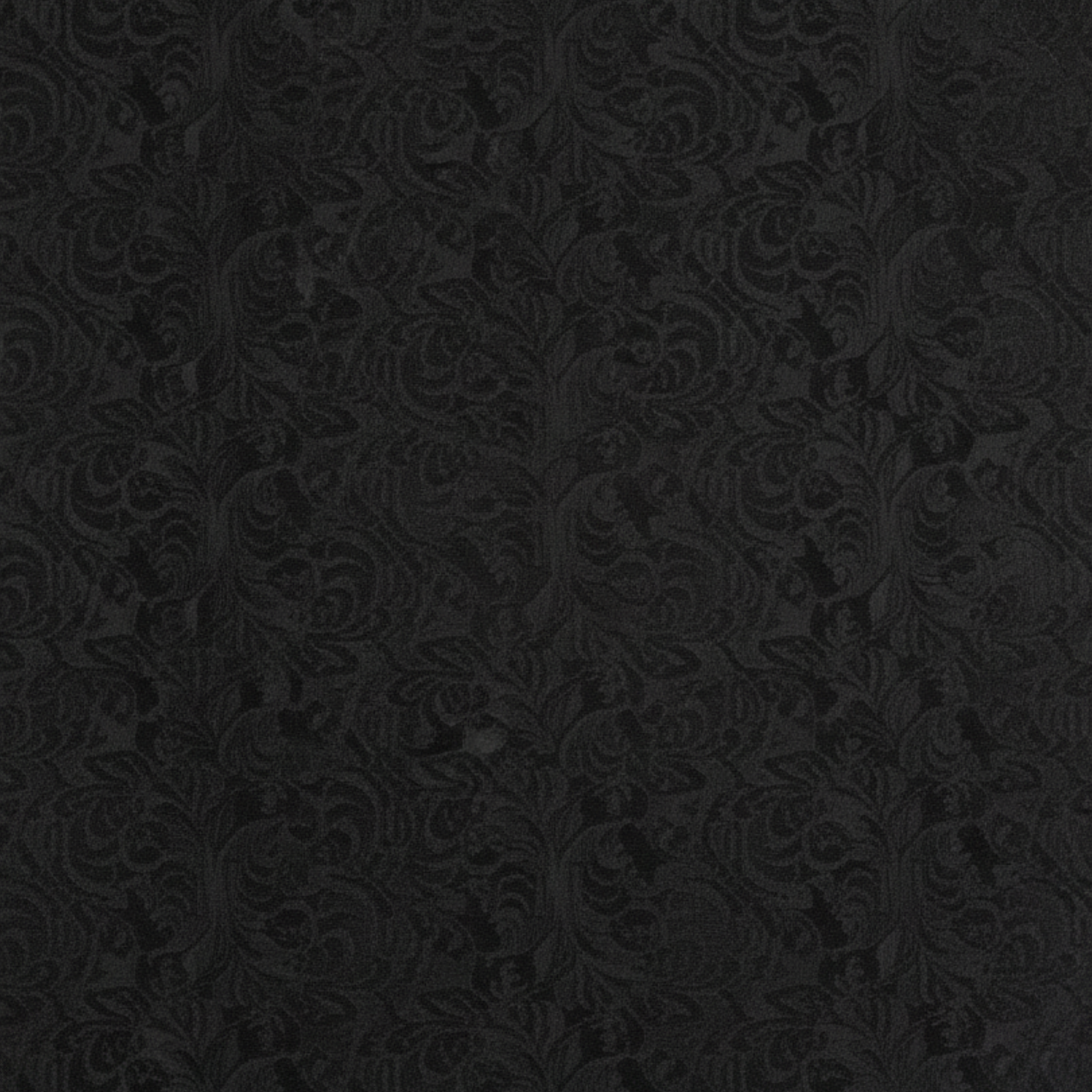 Close-up swatch of black floral brocade fabric used for the cropped jacket.