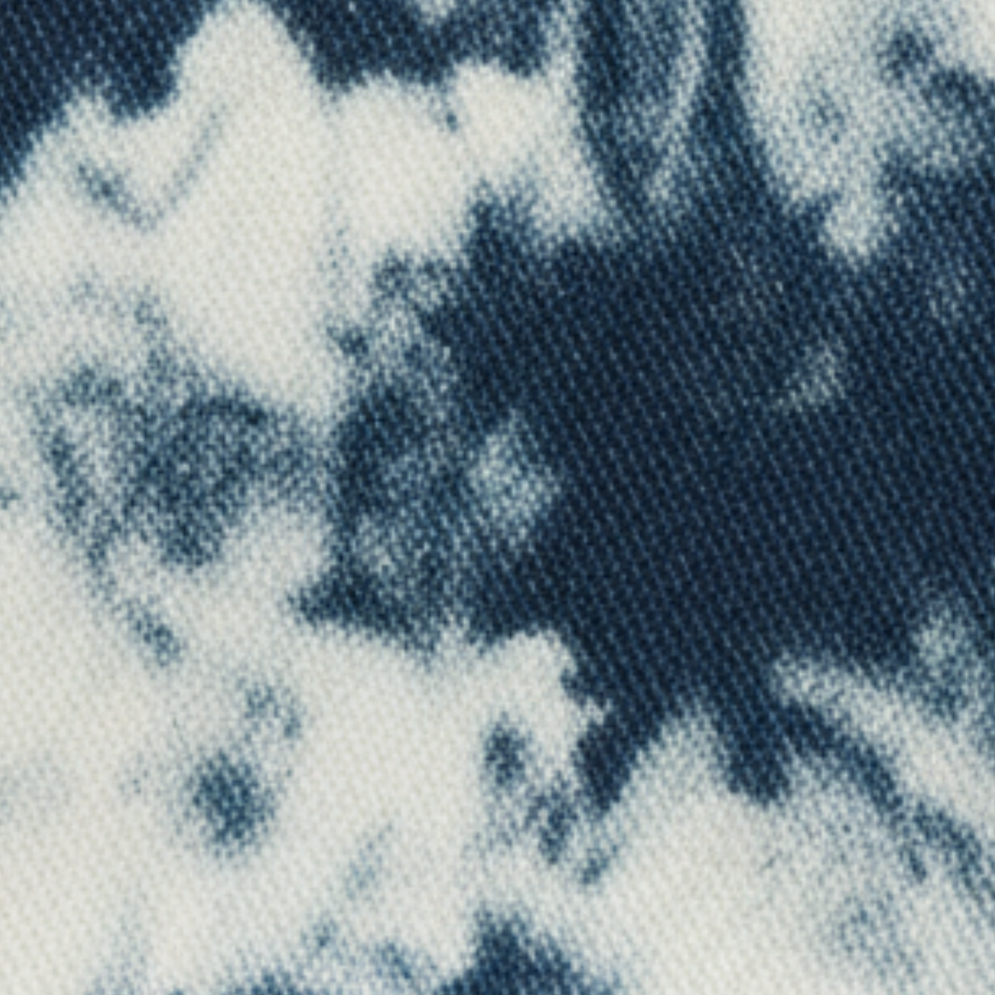 Tie-dye denim swatch showing navy bleached pattern and rugged cotton-denim texture