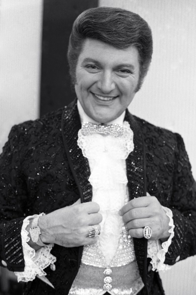 Liberace was known for his flamboyant showmanship, elaborate costumes, and extravagant lifestyle. 