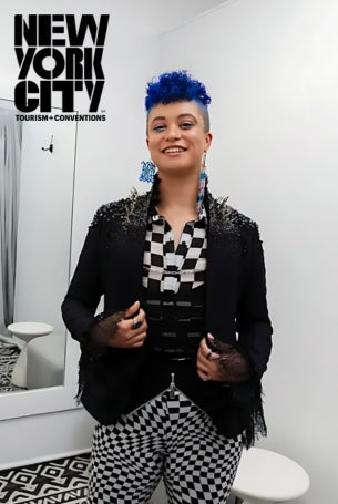 A young woman in a black blazer and checkered pants.