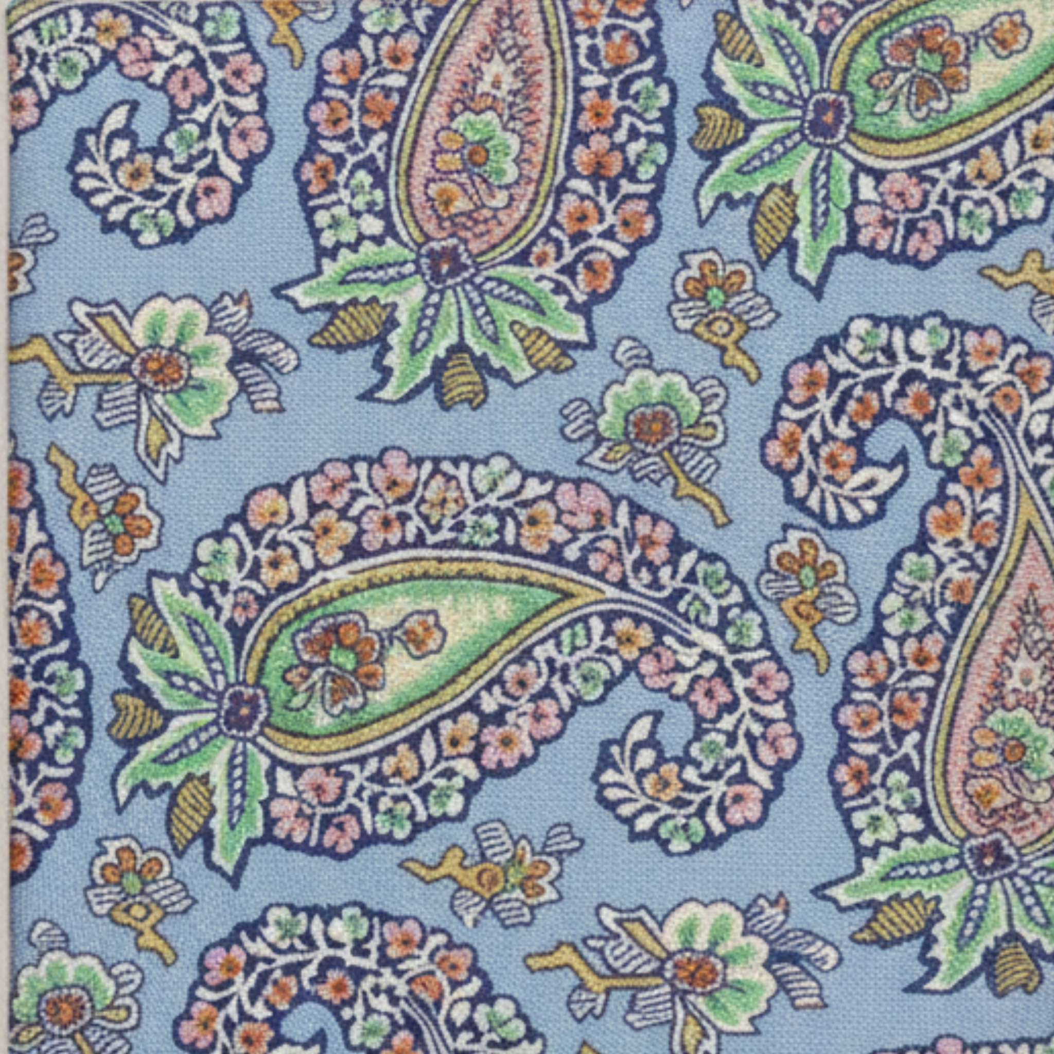 Close-up fabric swatch of paisley patterned woven silk tie texture and detail